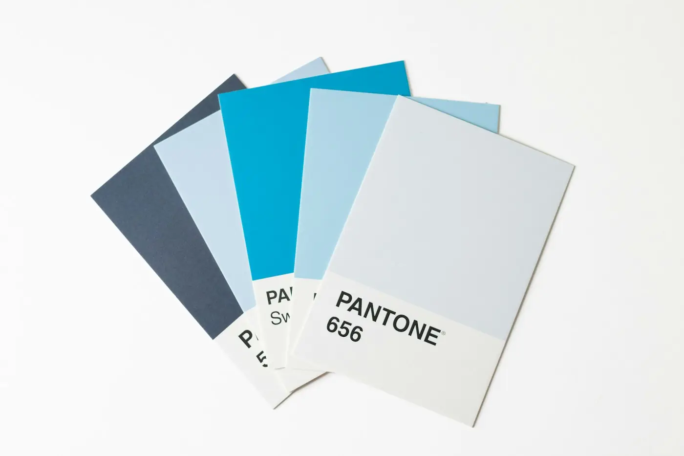 A fan of Pantone color swatches in shades of blue and gray