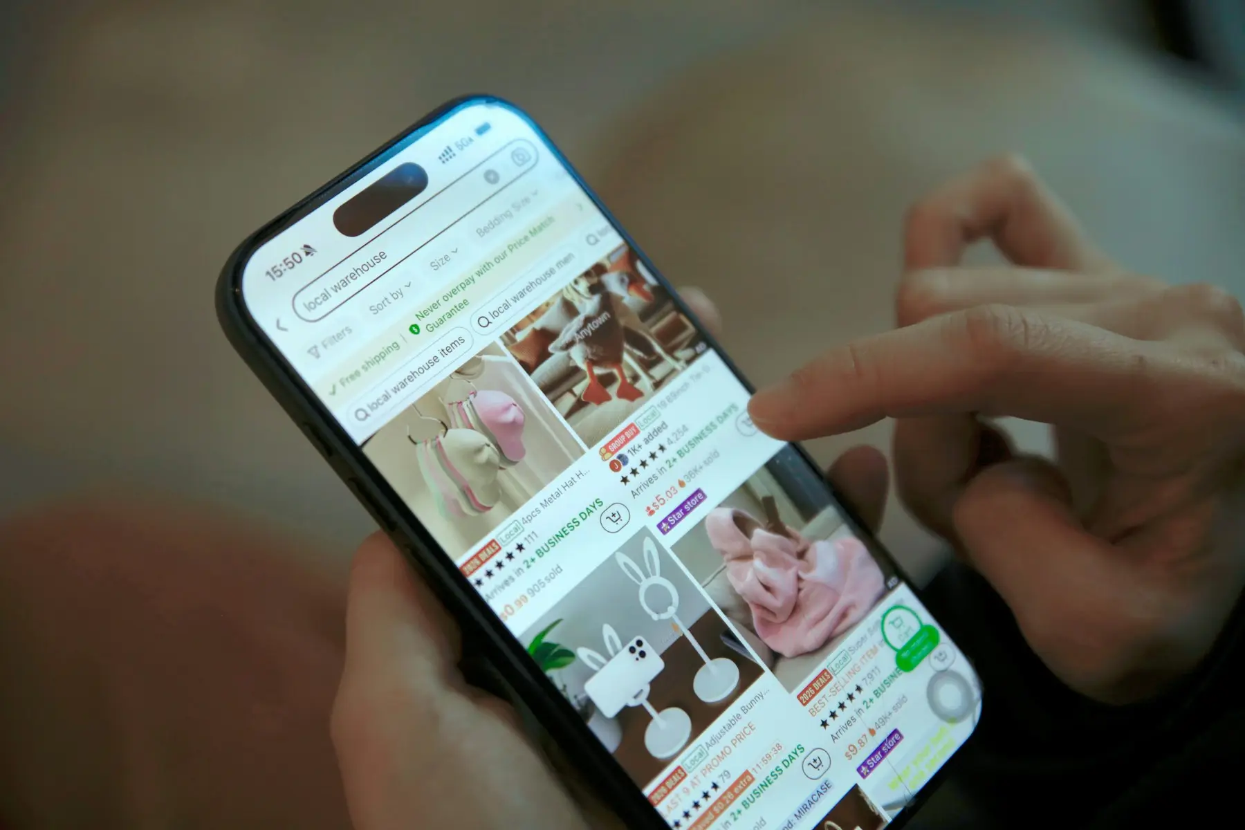 A hand browsing products in a shopping app on a smartphone