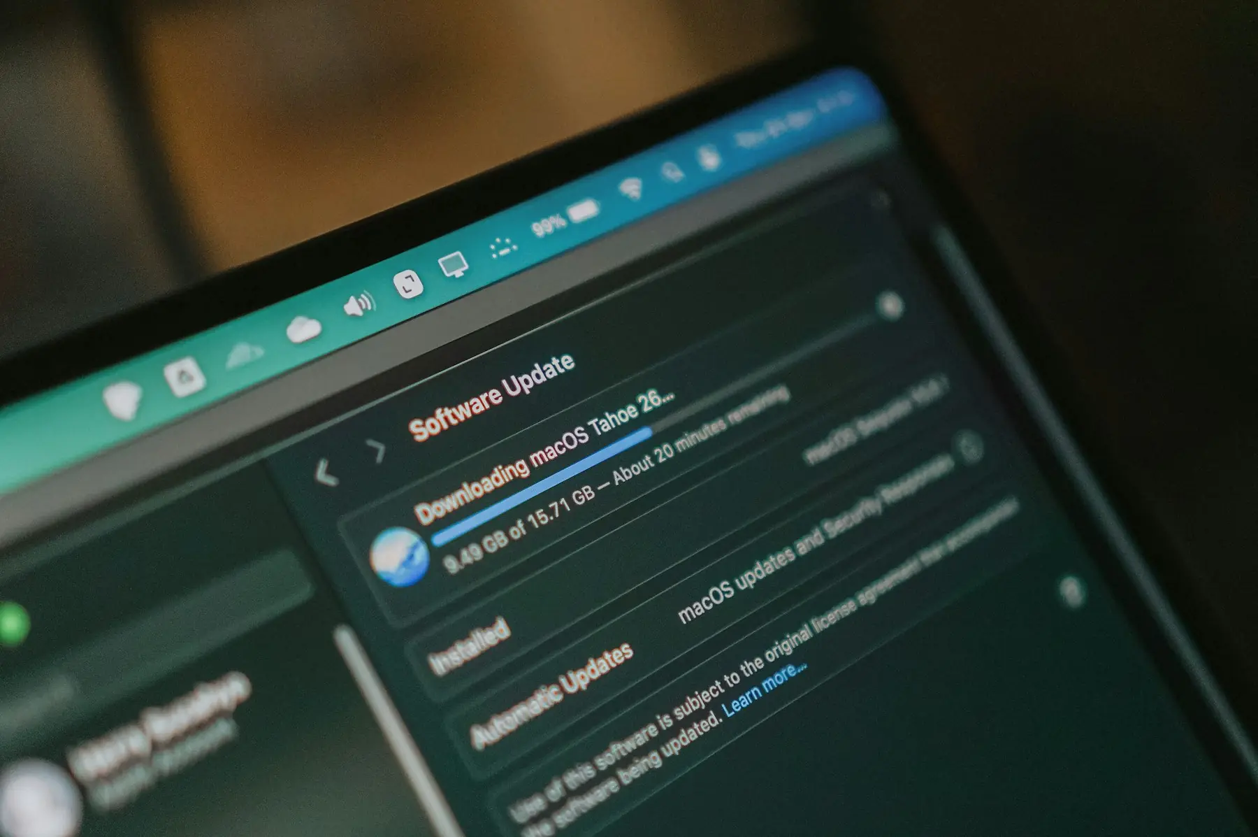 A laptop screen showing a software update downloading
